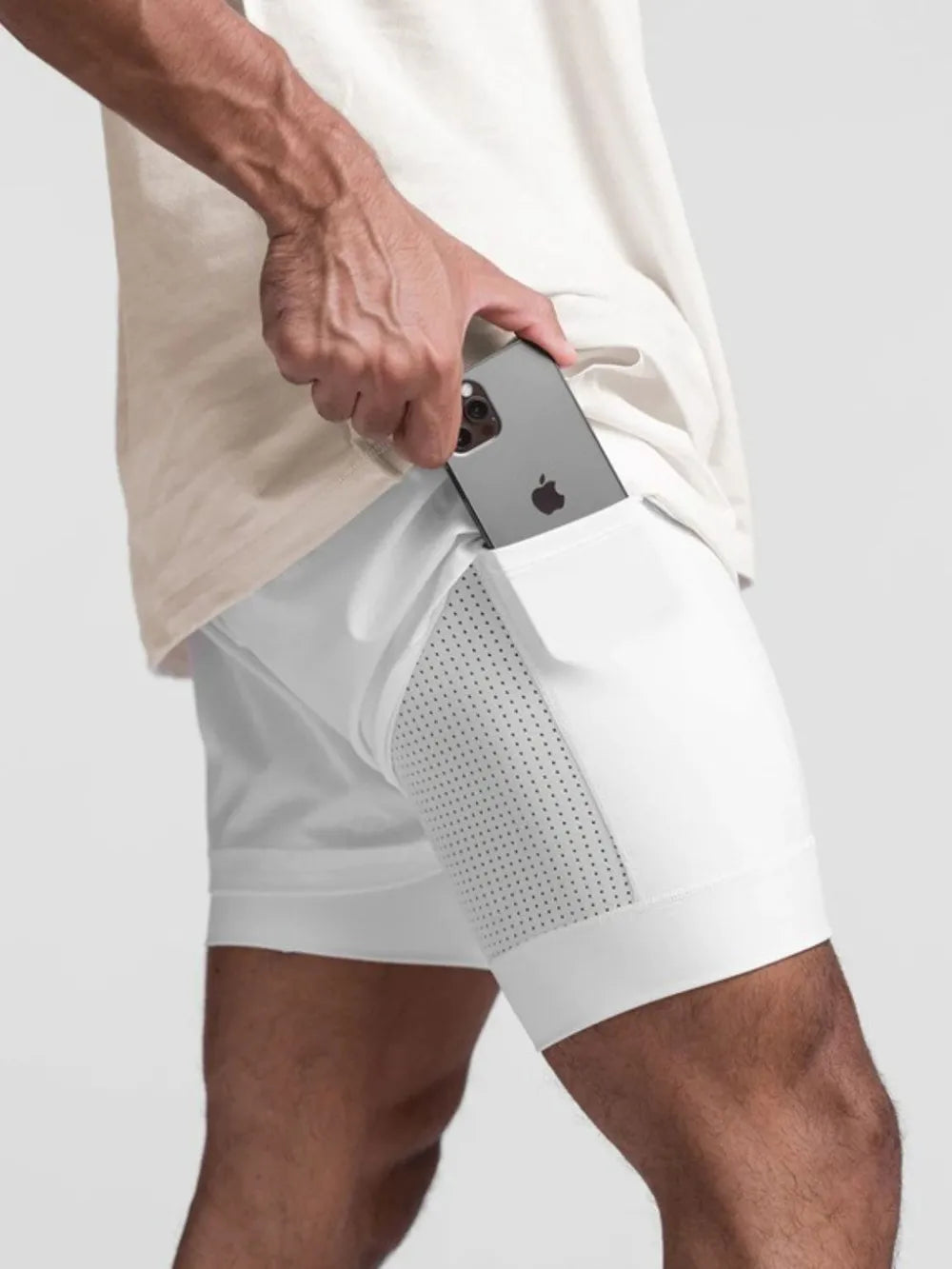 Trendsi white active shorts for men with side pocket holding a smartphone for convenient storage