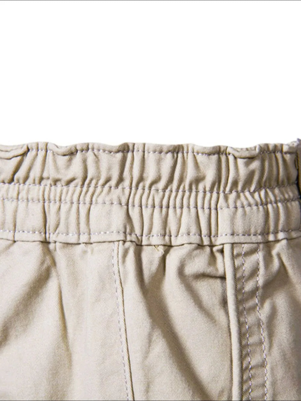 Close-up of waistband on comfortable bermuda shorts with pockets by Trendsi in beige fabric