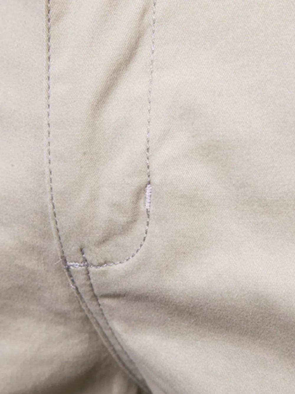 Close-up of Trendsi comfortable bermuda shorts with pockets featuring beige fabric and detailed stitching