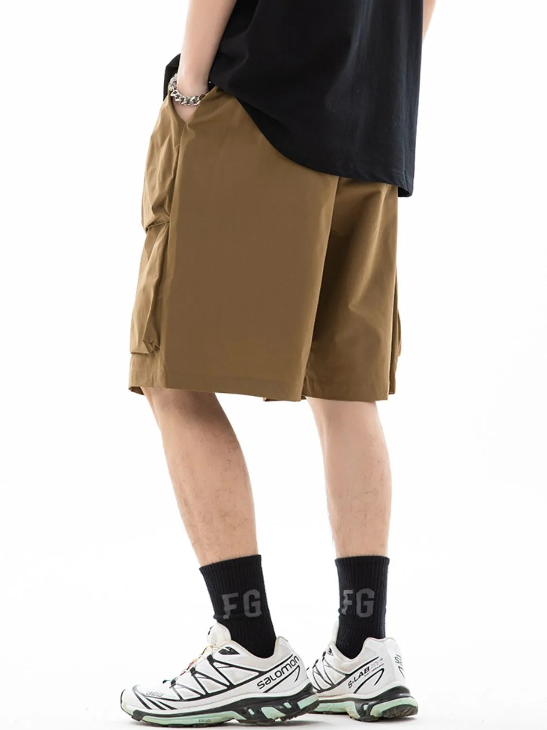 Trendsi brown drawstring pocketed shorts worn with black socks and white sneakers on male model