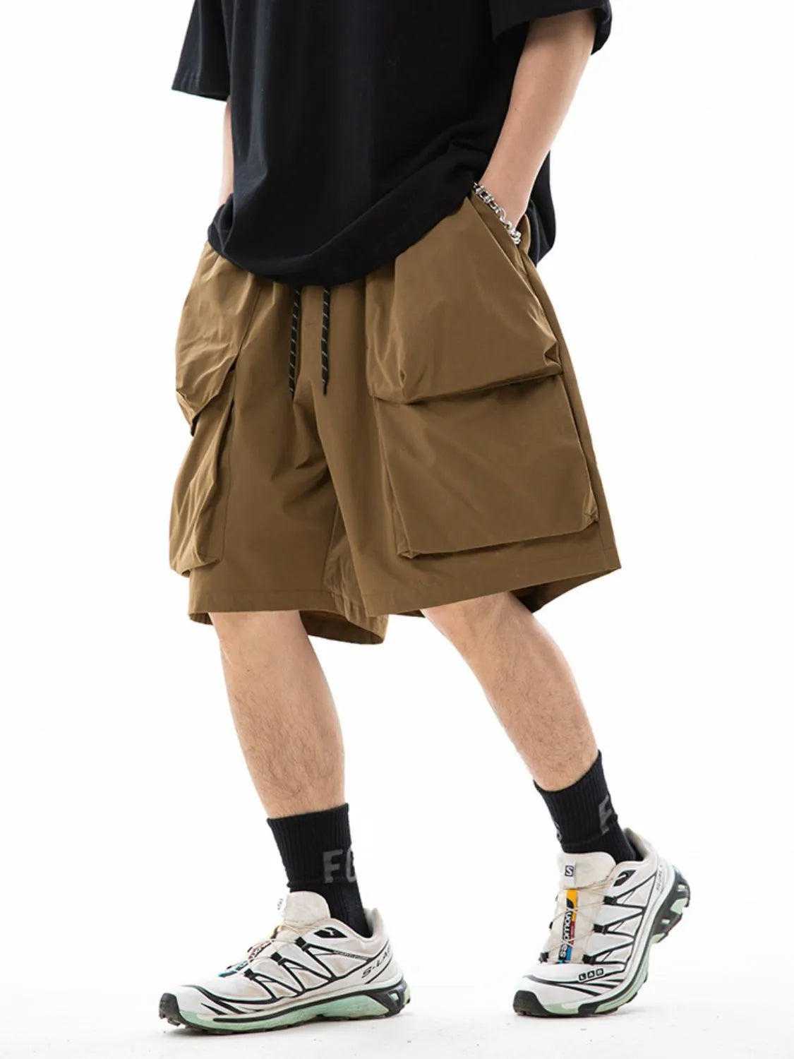 Trendsi brown drawstring pocketed shorts with large side pockets worn with black shirt and sneakers