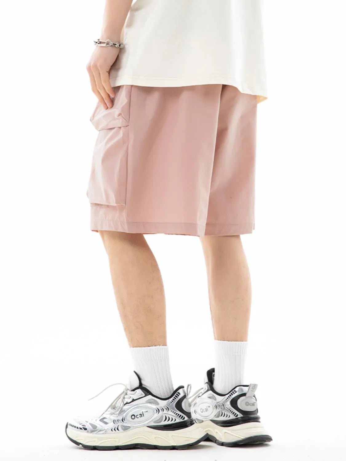 Trendsi drawstring pocketed shorts in light pink worn with white socks and black white sneakers