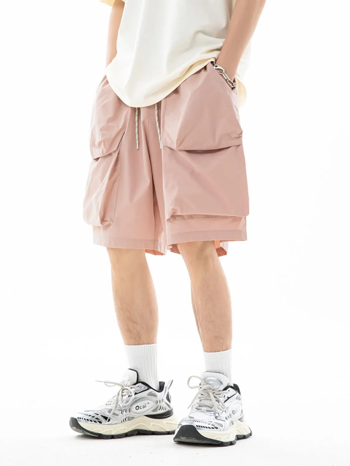 Trendsi drawstring pocketed shorts in light pink worn with white sneakers and socks