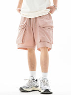 Trendsi drawstring pocketed shorts in light pink with multiple pockets worn with white sneakers