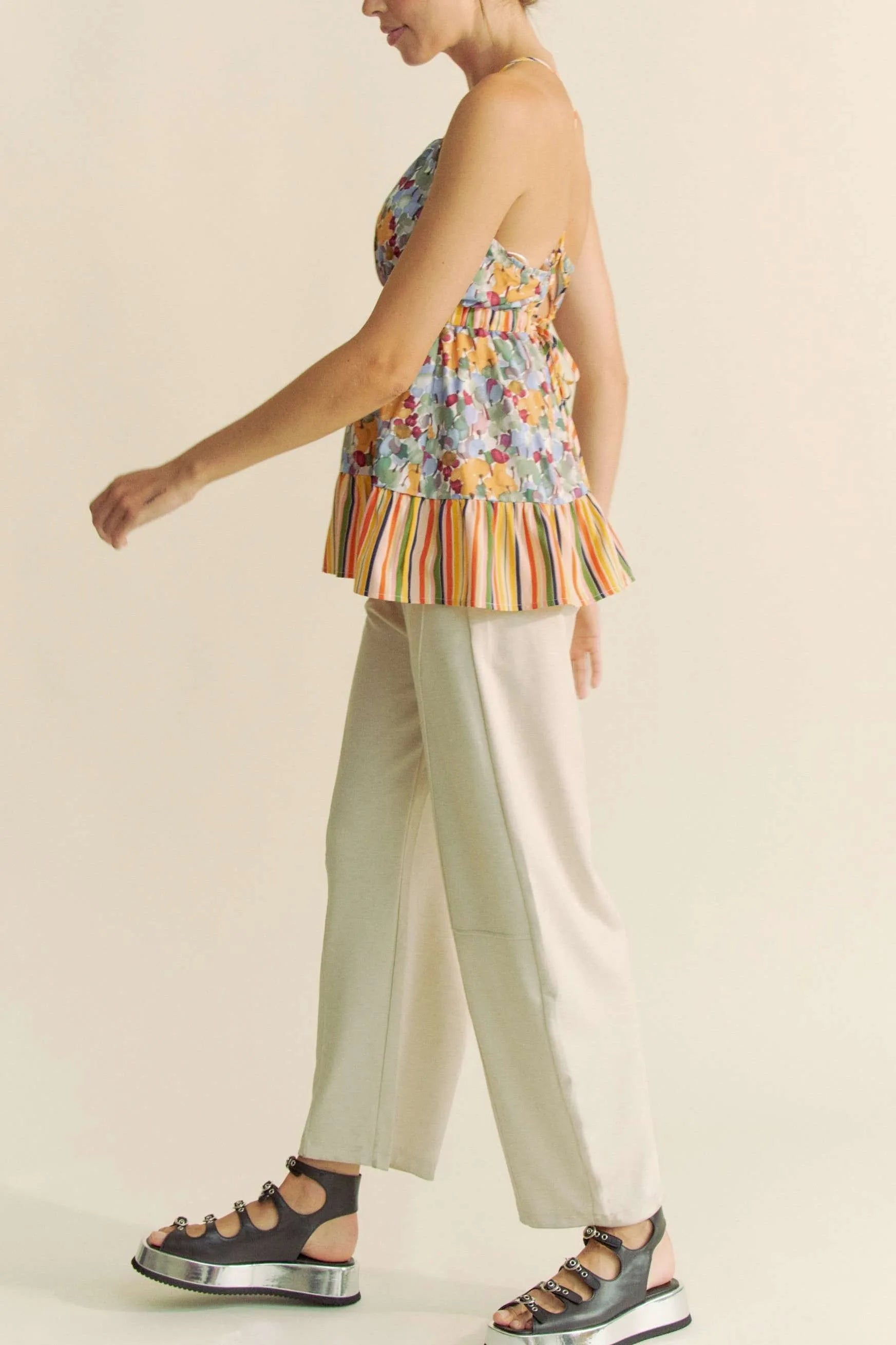 Trendsi floral smocked sleeveless top with colorful stripe hem paired with beige pants