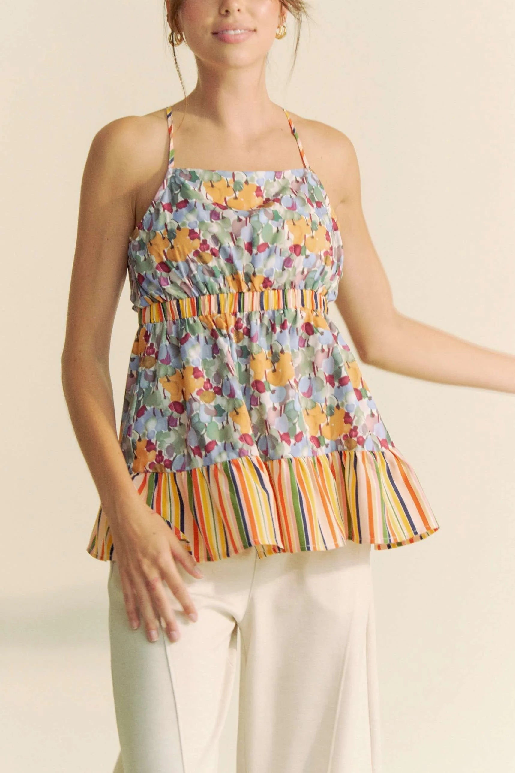  floral smocked sleeveless top with colorful floral print and striped ruffle hem
