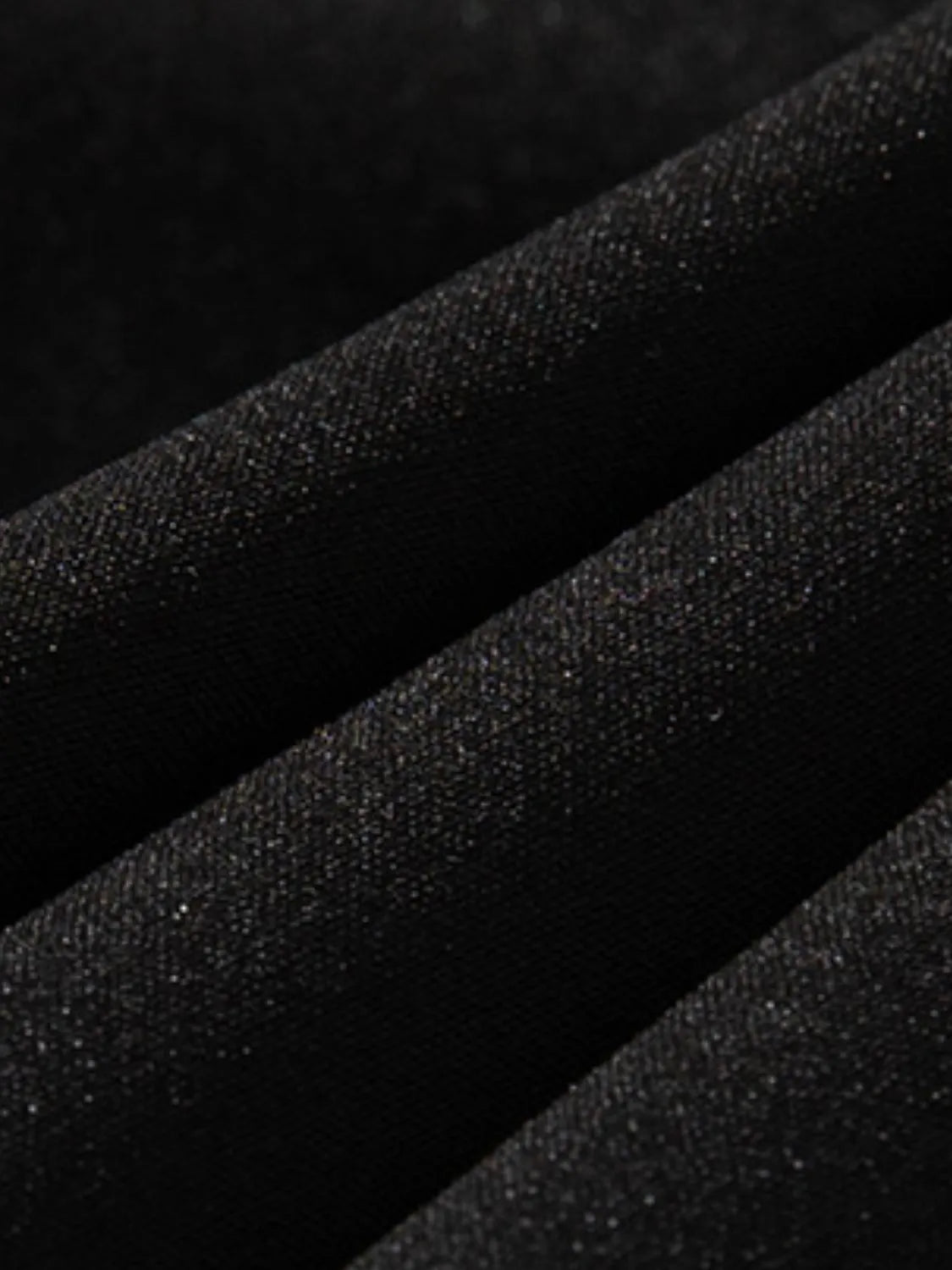 Close-up black fabric texture of men's plus size shorts by Trendsi for comfortable wear