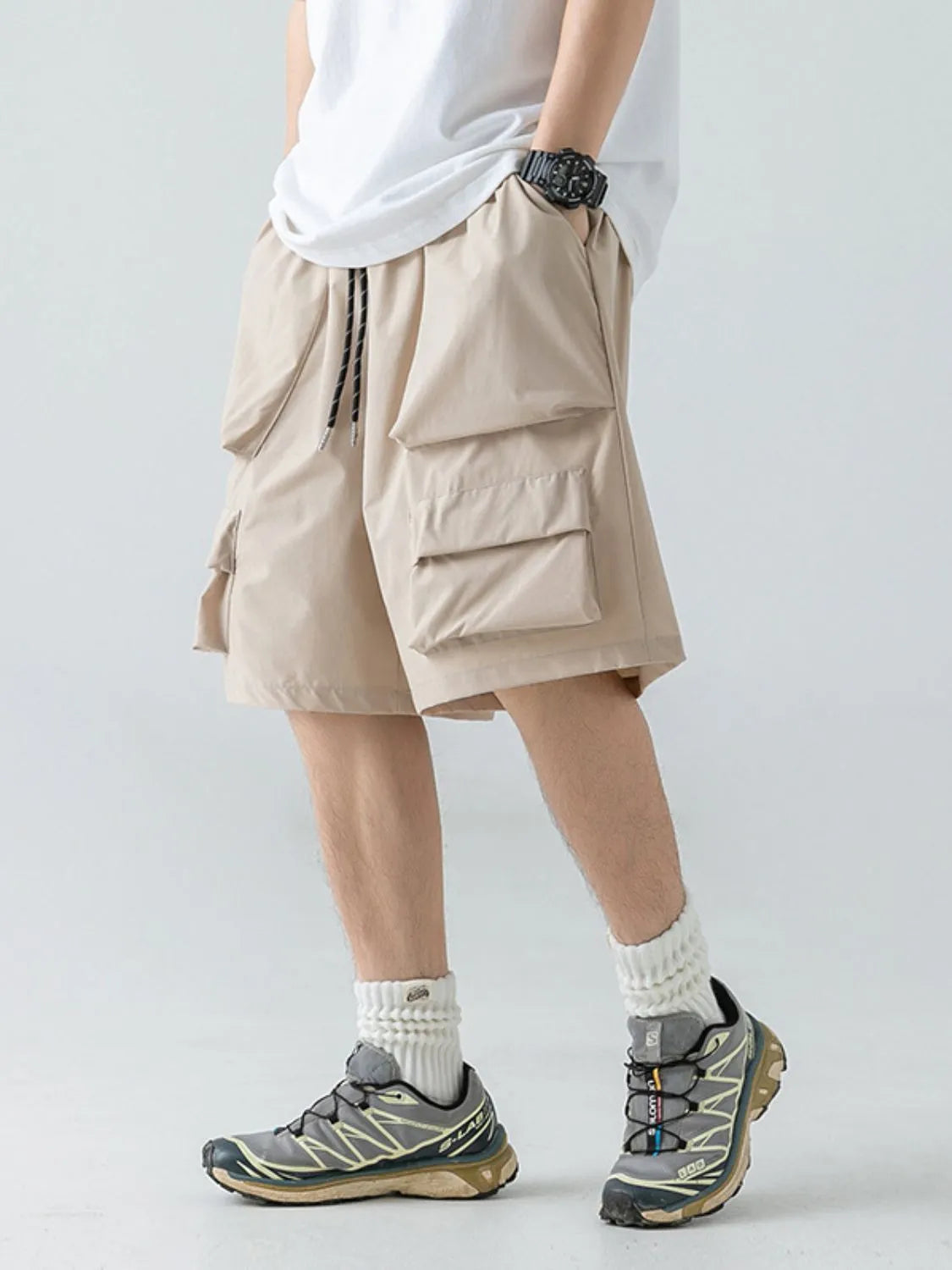 Trendsi men's summer shorts with pockets in beige cargo style worn with white socks and sneakers