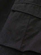 Close-up of black comfortable men's cargo shorts pocket detail by Trendsi