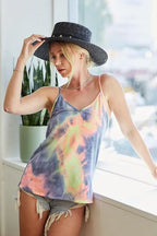 Trendsi tie dye knit cami vest in pastel colors worn with a black hat and denim shorts